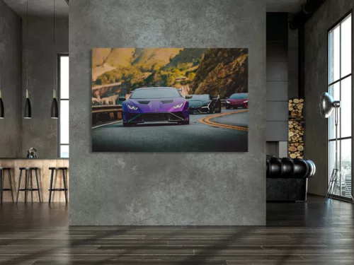 Photographies Lamborghini Party Photographie artistique d'un convoi de Lamborghini sur route sinueuse de montagne, avec une Huracán violette en premier plan suivie de plusieurs supercars italiennes