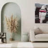 empty poster frame on beige wall in living room interior with mo Photographie de Ferrari 275 GTB montrant une personne en tenue d'hiver blanche avec équipement de ski monté sur une Ferrari argentée classique au Concours d'Élégance de St. Moritz 2023