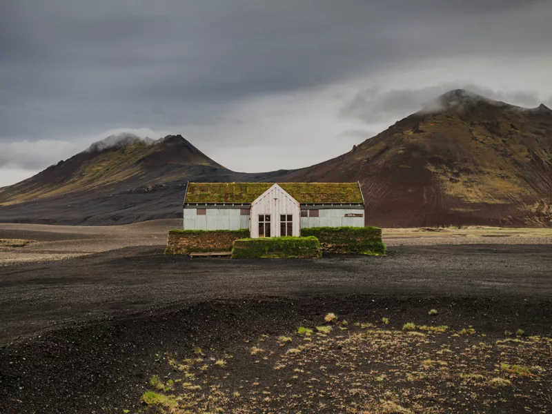 Restaurant solitaire couvert de mousse dans les hautes terres volcaniques du nord-est de l'Islande près de Möðrudalsleið avec montagnes dramatiques