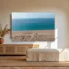 Tableau plage Zahara de los Atunes mockup Tableau photographie de la plage de Zahara de los Atunes en Espagne au-dessus d'un buffet en rotin dans un salon andalou lumineux